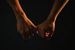 Two hands reaching and gently touching in the dark, symbolising reconnection and emotional closeness