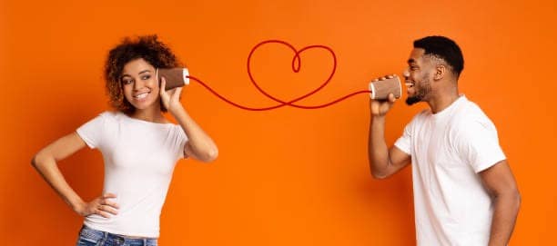 Man and woman using a string phone to communicate, representing effort and connection in relationships
