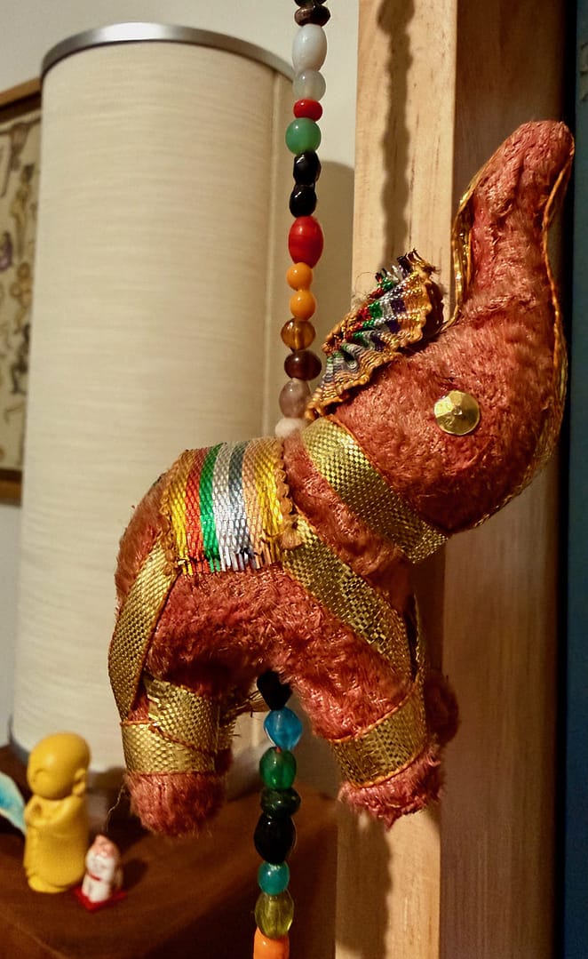 Decorative hanging elephant representing the hidden beliefs we carry while chasing achievement and personal growth.