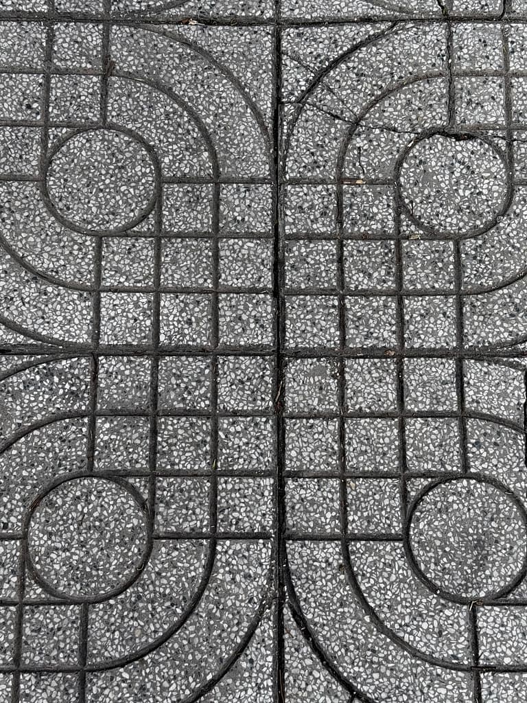 Grey geometric paving pattern viewed from above.